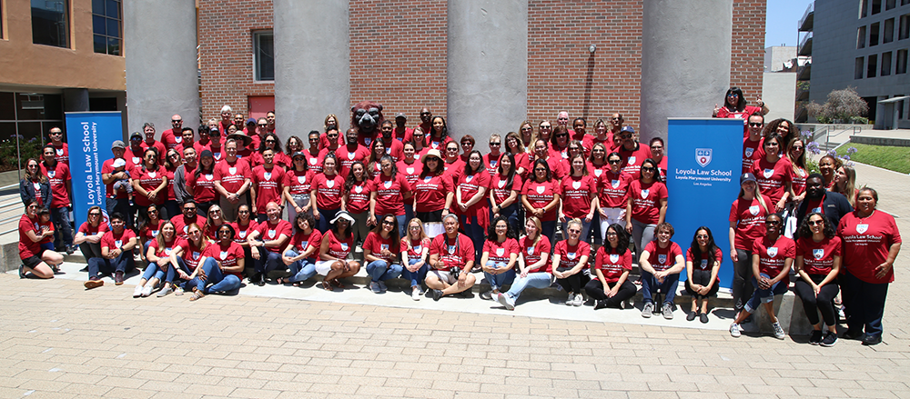 Group Photo of LLS Faculty and Staff team with newly branded pull up banners