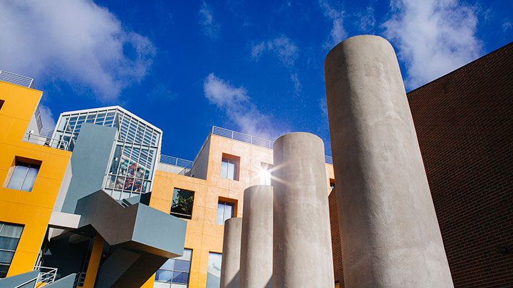 An upward-facing shot of the LLS buildings with a blue sky above